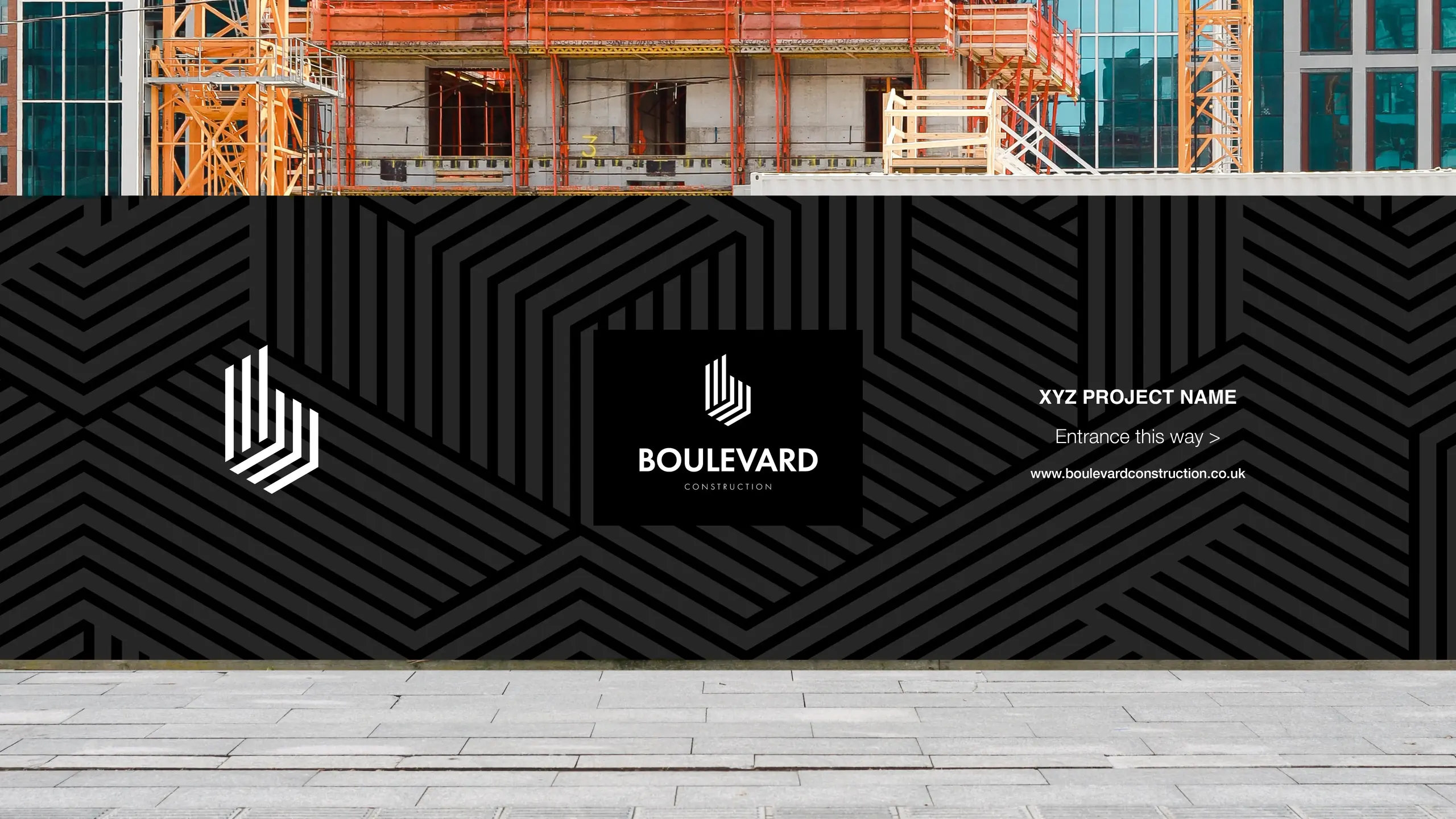 Construction site with black patterned hoarding displaying Boulevard Construction logo and text reading XYZ Project Name, Entrance this way, and website URL.